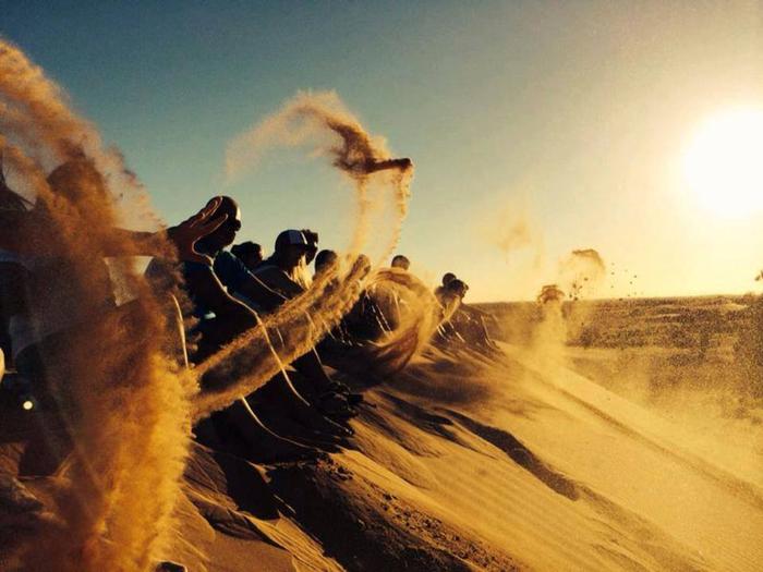 people sliding down perry sandhills
